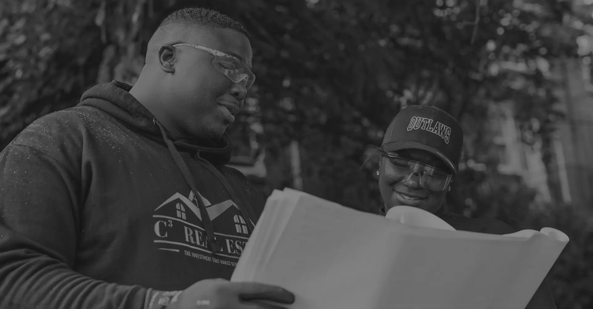 Two C-Cubed Contracting team members reviewing project drawings on site