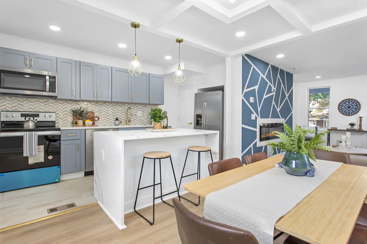 Renovated kitchen with a custom island, pendant lighting and new cabinetry